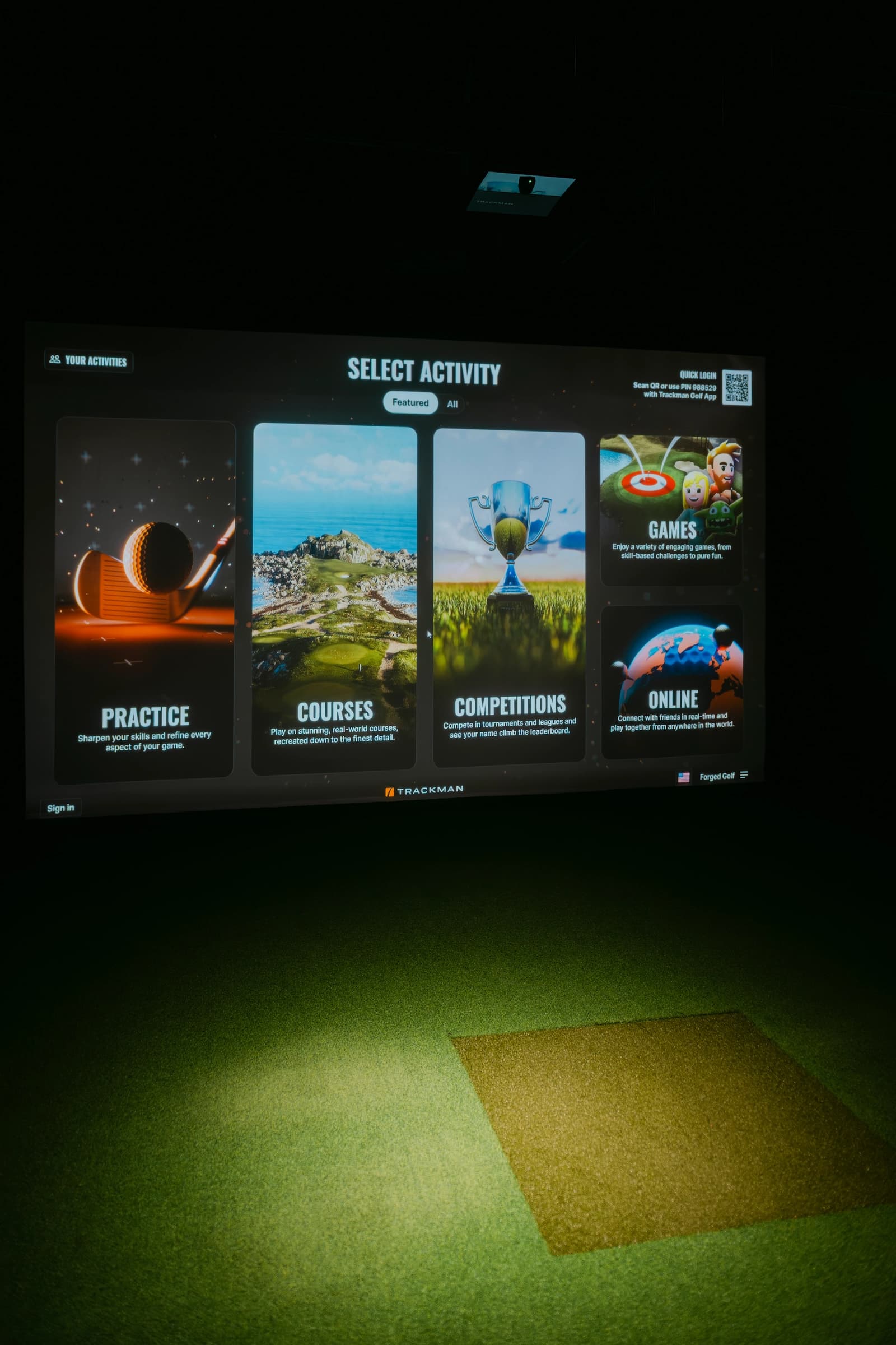 Golf simulator impact screen and hitting area at Forged Golf