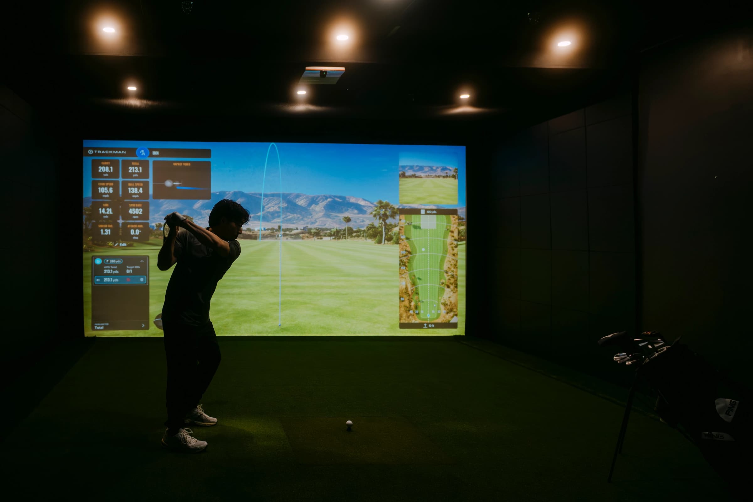 Solo player enjoying an indoor golf simulator session at Forged Golf