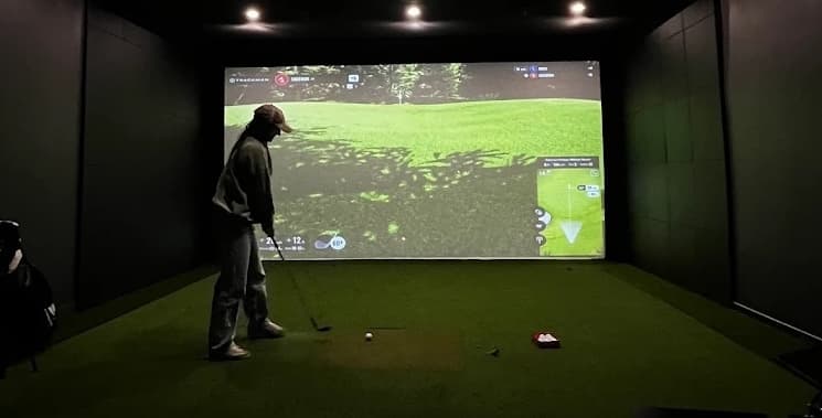 Solo player enjoying an indoor golf simulator session at Forged Golf